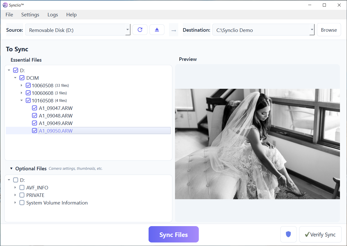 Synclio application main window showing transfer in progress. The interface displays file transfer details with verification status indicators in a professional desktop environment. The window conveys reliable, secure file handling with clear status feedback for photographers managing their media transfer workflow.